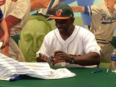 Cubs Legend, Andre Dawson signing autographs for fans at a Joliet Slammers game.